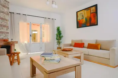 a living room with a couch and a table at Casa Nova Maison moderne à deux pas de la plage in Bouznika