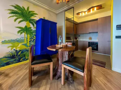 a kitchen with a table and chairs and a blue cabinet at Maya Suites - Premium Luxury Stay in Casablanca