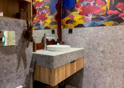 a bathroom with a sink and a painting on the wall at Maya Suites - Premium Luxury Stay in Casablanca