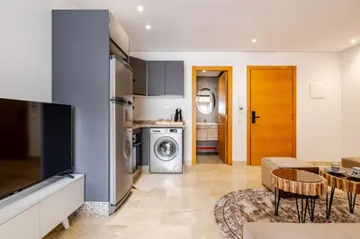 a kitchen and living room with a washer and dryer at 1- Bourgogne City Escape in Casablanca