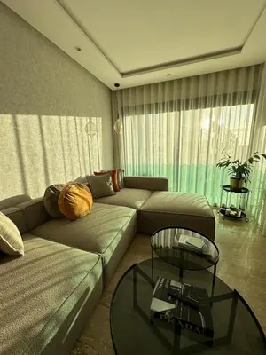 a living room with a couch and a glass table at Cosy Family 2BR Apartment - Terrace & Sunset Views in Casablanca