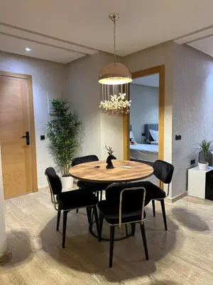 a dining room table with chairs and a chandelier at Cosy Family 2BR Apartment - Terrace & Sunset Views in Casablanca