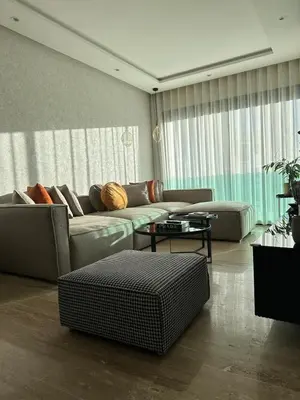 a living room with a couch and a table at Cosy Family 2BR Apartment - Terrace & Sunset Views in Casablanca