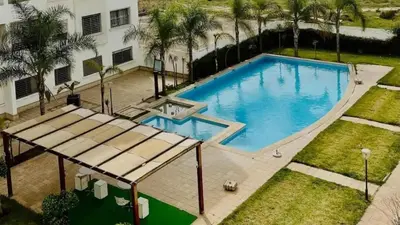 an overhead view of a swimming pool in a yard at Calme & Cocon Apartment Near Airport in Nouaceur