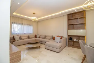 a living room with a couch and a table at Calme & Cocon Apartment Near Airport in Nouaceur