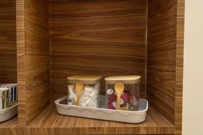 a cupboard with two jars and spoons in it at Calme & Cocon Apartment Near Airport in Nouaceur