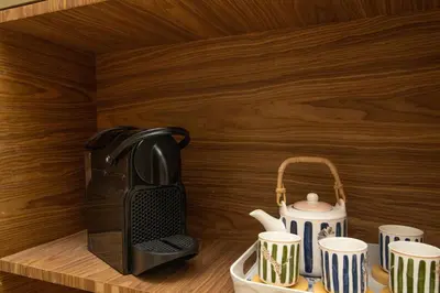 a tea kettle and tea cups on a counter at Calme & Cocon Apartment Near Airport in Nouaceur