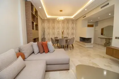 a living room with a couch and a table at Calme & Cocon Apartment Near Airport in Nouaceur