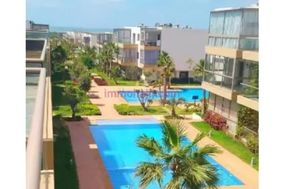 an apartment with a swimming pool in a building at Appart pour Famille balnéaire Accés direct à la Mer in Sidi Rahal