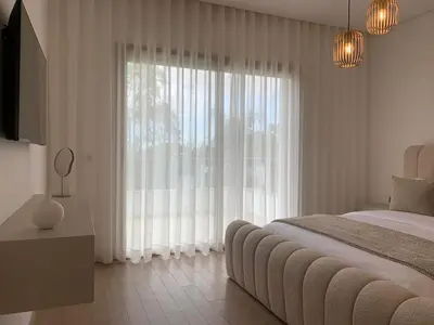 a bedroom with a bed and a large window at Villa Moderne et élégante Piscine Golf Resort in Casablanca