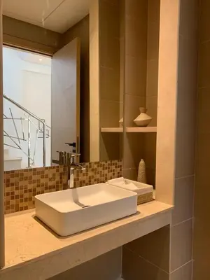 a bathroom with a white sink and a mirror at Villa Moderne et élégante Piscine Golf Resort in Casablanca