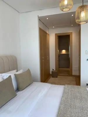 a bedroom with a large white bed with two pillows at Villa Moderne et élégante Piscine Golf Resort in Casablanca