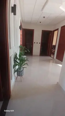 a potted plant sitting in the middle of a hallway at Résidence yassine in Rabat