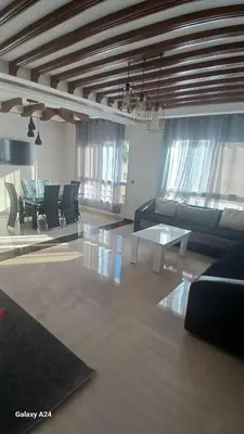 a living room with a couch and a table at Résidence yassine in Rabat