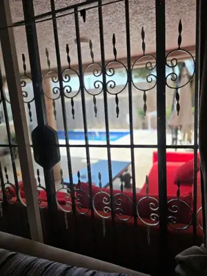 a window with raindrops on a wrought iron fence at Appartement villa in Temara