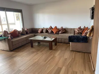a living room with a couch and a coffee table at Blue Beach in Sidi Rahal