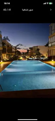 a picture of a swimming pool at night at Blue Beach in Sidi Rahal