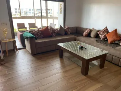 a living room with a couch and a coffee table at Blue Beach in Sidi Rahal