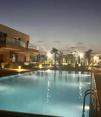 a large swimming pool in front of a building at Blue Beach in Sidi Rahal