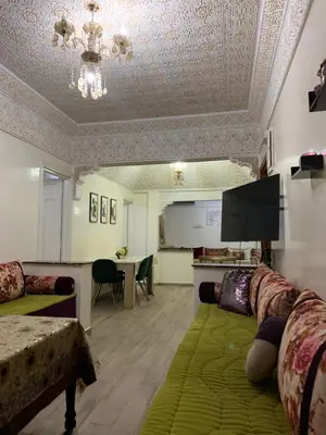 a living room with a couch and a table at الدروة in Derroua