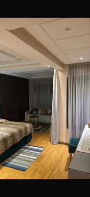a bedroom with a bed and a couch in it at CityCore duplex in Casablanca
