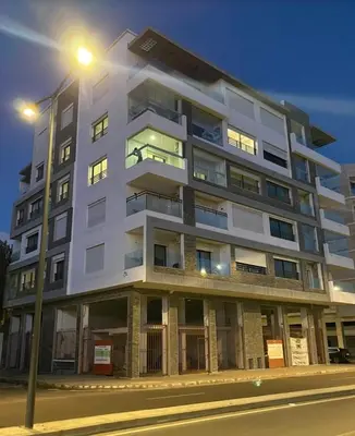 a tall white building with a street light at CityCore duplex in Casablanca