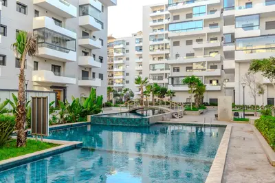 a swimming pool in front of a building at VIVASTAY Casablanca - Ocean Park Sunset Escape beach front with swimming pool in Aïn Harrouda