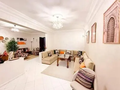 a large living room with couches and a table at Horizon bleu in Rabat