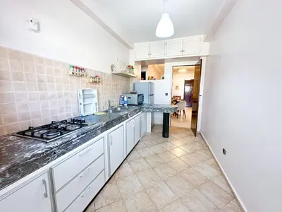 a kitchen with white cabinets and a counter top at Horizon bleu in Rabat