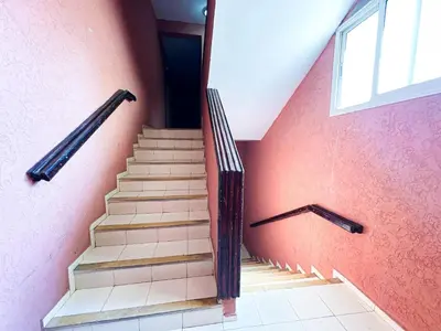 a staircase in a room with a red wall at Horizon bleu in Rabat