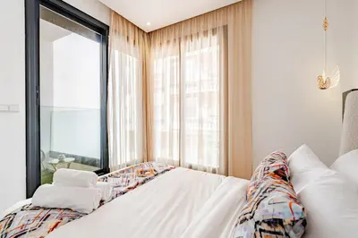 a bedroom with a bed and a large window at 2 - Bourgogne City Escape in Casablanca