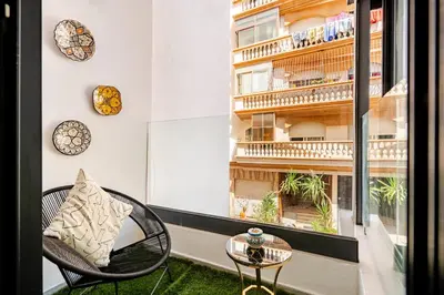 a room with a chair and a table and a window at 2 - Bourgogne City Escape in Casablanca