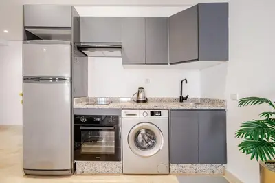 a kitchen with a washing machine and a washer at 2 - Bourgogne City Escape in Casablanca