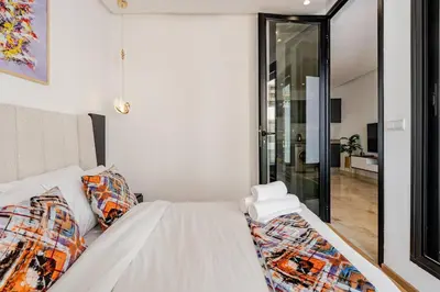 a white bed in a room with a glass door at 2 - Bourgogne City Escape in Casablanca