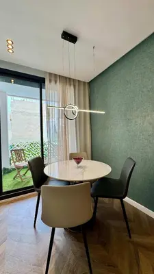 a dining room with a table and chairs at Urban Apartment 2 Mars - By AppartAli in Casablanca