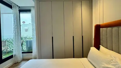 a bedroom with a bed and a large window at Urban Apartment 2 Mars - By AppartAli in Casablanca