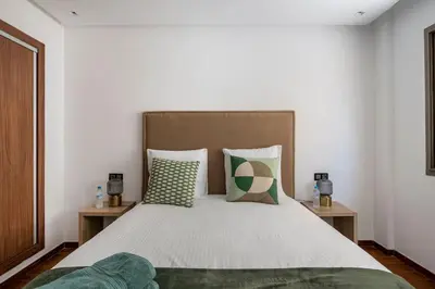 a bedroom with a large white bed with pillows at Appartement neuf et moderne à l'Agdal, 2 chambres in Rabat