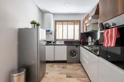 a kitchen with a refrigerator and a washing machine at Appartement neuf et moderne à l'Agdal, 2 chambres in Rabat