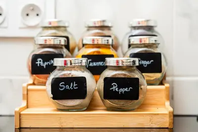 a group of glass jars of food on a wooden stand at Bright apartment Maarif, 2 bedrooms, Wi-Fi, AC in Casablanca