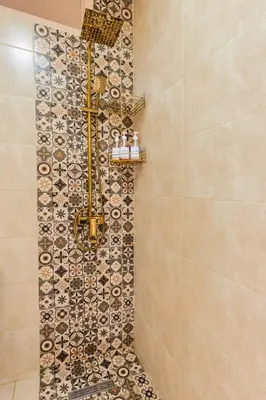 a shower in a bathroom with a mosaic tile wall at Bright apartment Maarif, 2 bedrooms, Wi-Fi, AC in Casablanca