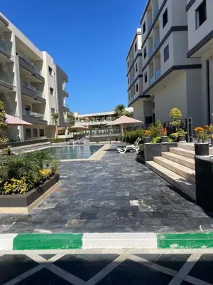 a swimming pool in the middle of a building at Résidence Beach Land El Mansouria in Mohammedia