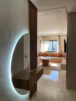 a living room with a couch and a table at Résidence Beach Land El Mansouria in Mohammedia
