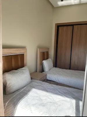 two beds in a small room with two beds at Résidence Beach Land El Mansouria in Mohammedia