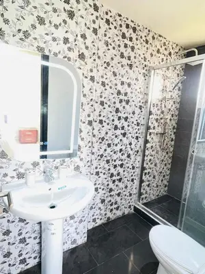 a bathroom with a sink and a shower at Stunning Sunny Villa, near airport in Derroua
