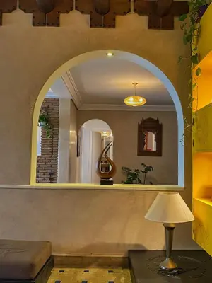 a living room with a large mirror and a lamp at Marrakech atmosphere in Casablanca in Casablanca