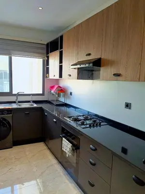 a kitchen with a sink and a stove top oven at Palmier house for family only in Maarif