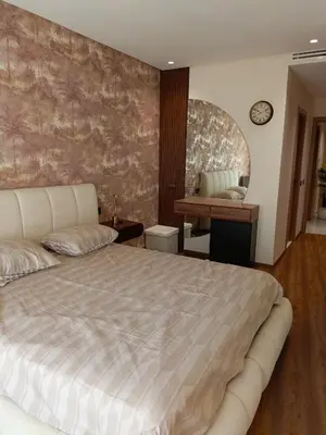 a bedroom with a large bed and a desk at Palmier house for family only in Maarif