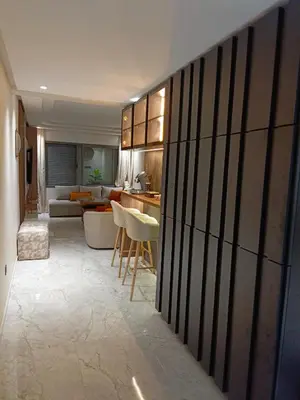 a living room with a kitchen and a living room with a couch at Palmier house for family only in Maarif