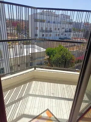 a balcony with a view of a city at Palmier house for family only in Maarif