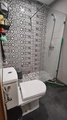 a bathroom with a shower and a white toilet at Bel appartement in Casablanca